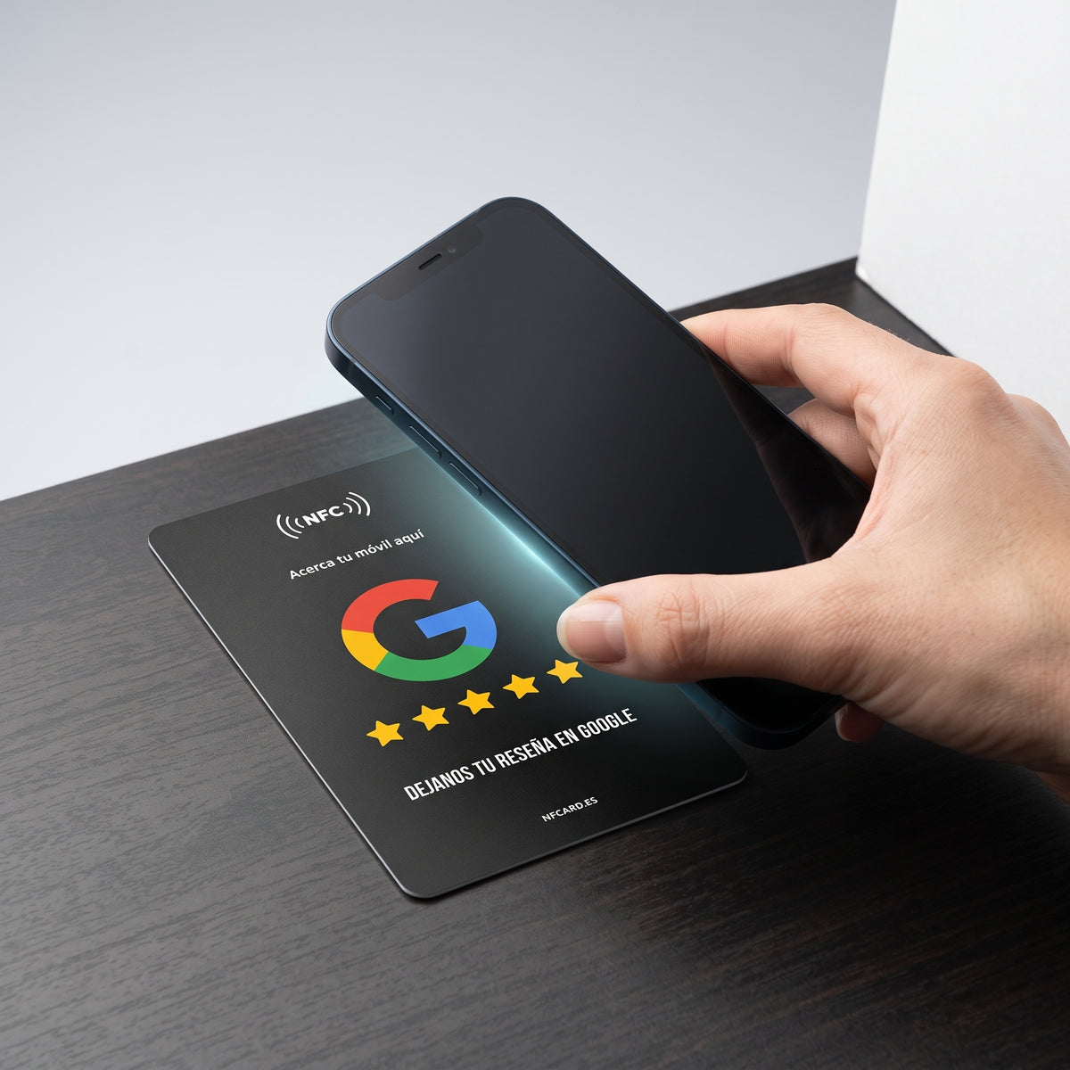 Móvil acercándose a la tarjeta NFC para abrir la reseña de Google en un toque